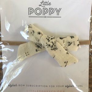 Little Poppy co cream and black floral bow